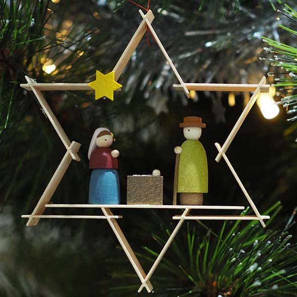 In this Christmas tree decoration from The German Christmas Shop the Holy Family (Jesus Mary and Joseph) are framed within a natural wooden star
